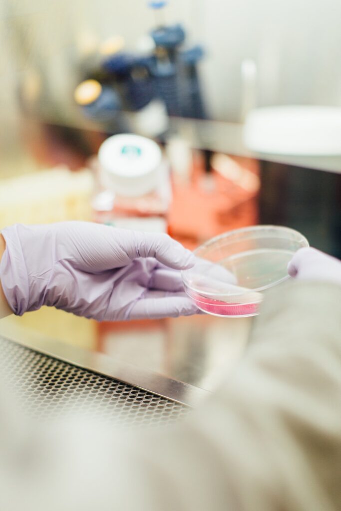 scientist holding a petri dish.