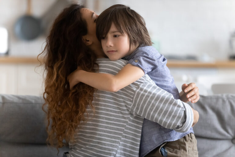 Lovely mom embracing and supporting child in difficult times.