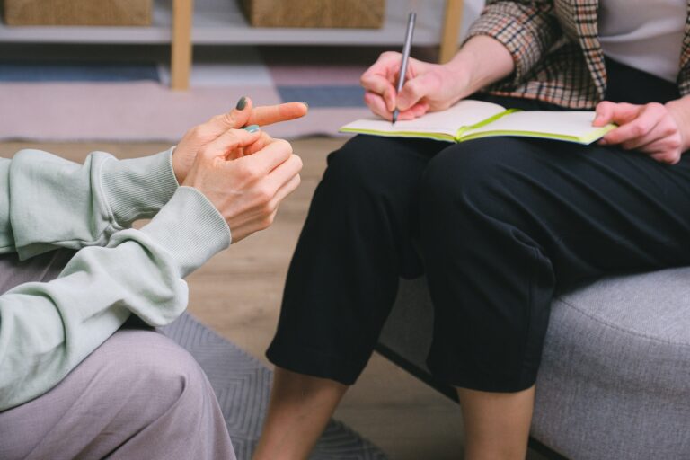 Doctor and patient discussing together on a couch.