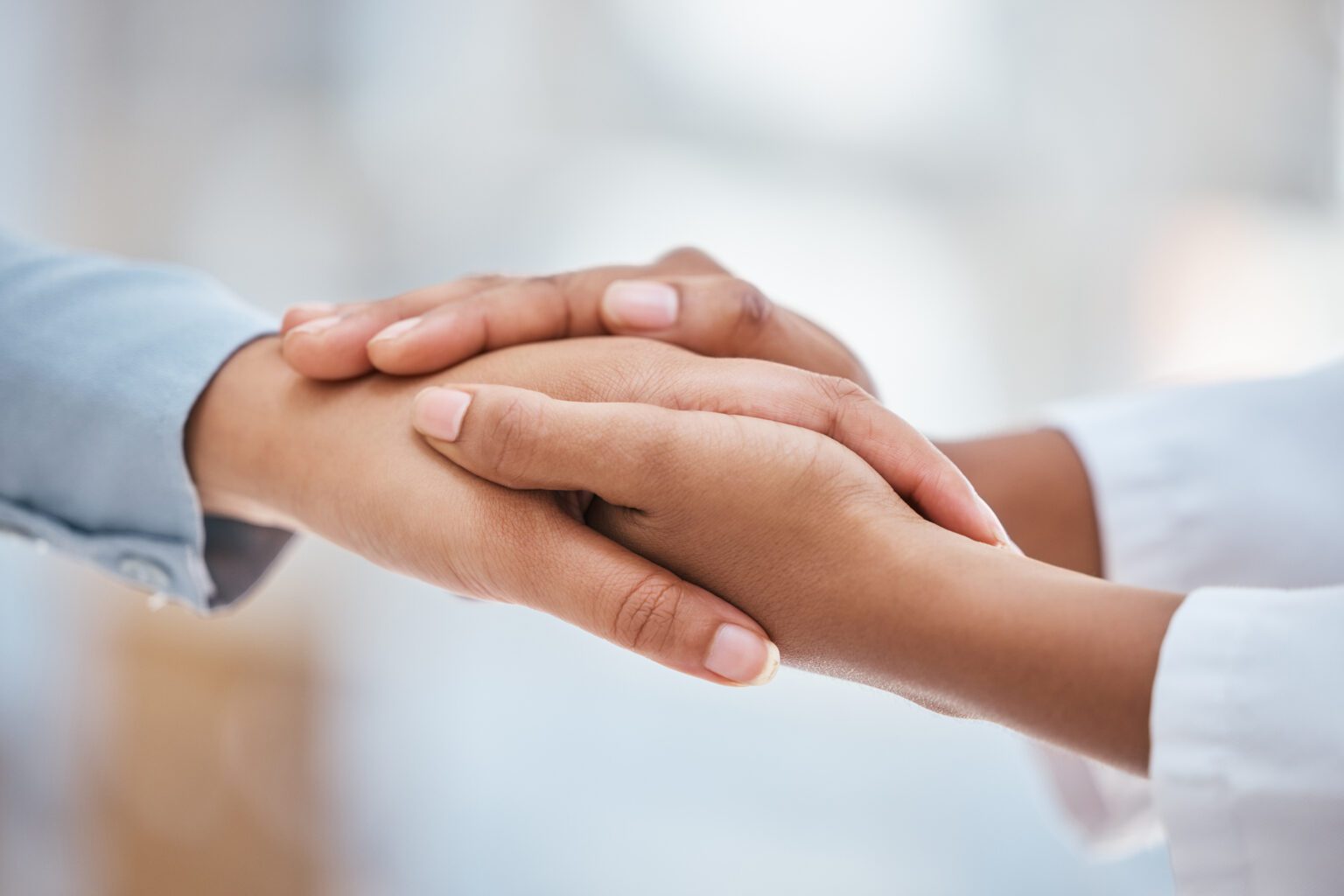 Doctor, women or holding hands in support, trust or medical wellness in hospital with anxiety stress.