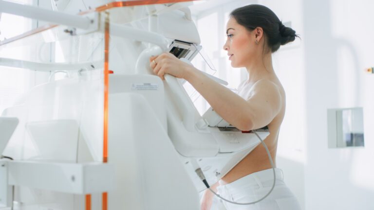 In the Hospital, Portrait Shot of Topless Female Patient Undergoing Mammogram Screening Procedure. Healthy Young Female Does Cancer Preventive Mammography Scan. Modern Hospital with High Tech Machines.